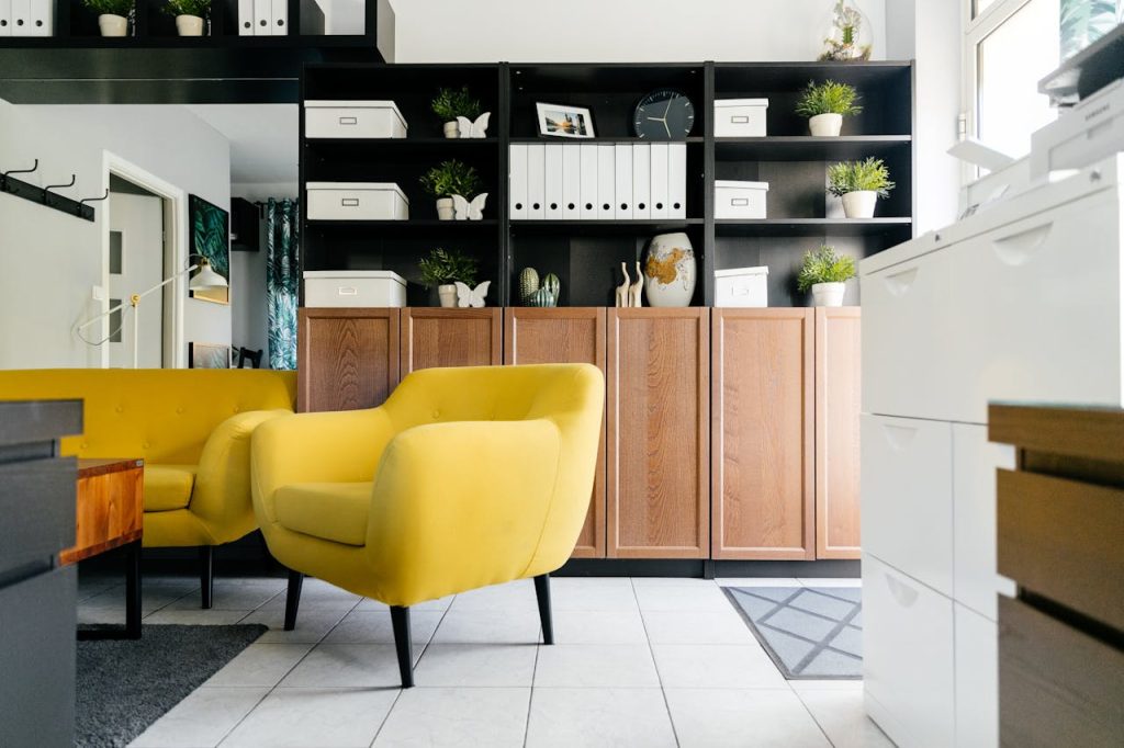 interior-of-stylish-living-room-with-yellow-soft-furniture-4138152 Creative yellow armchairs placed near wooden coffee table in cozy living room with creative shelves decorative houseplants